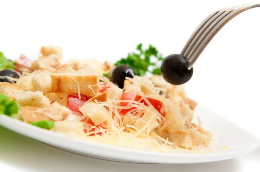 A salad in a stylish white bowl.