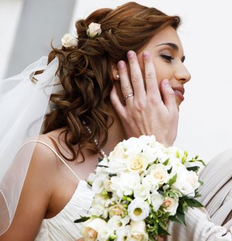 Portrait of the beautiful bride with a bouquet