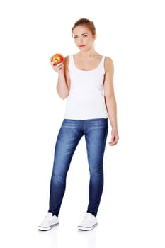 Young beautiful caucasain girl eating an apple. Isolated on white.