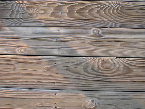 A photograph of wood boards detailing their texture and grain.