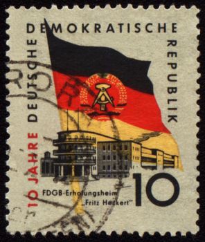 GDR - CIRCA 1959: a stamp printed in GDR (East Germany), shows holiday home and State flag of GDR, circa 1959