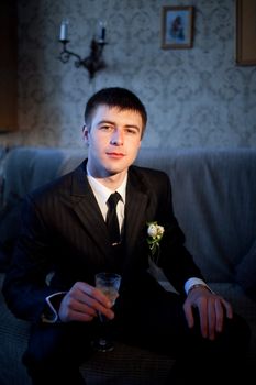 a groom with glass of champagne