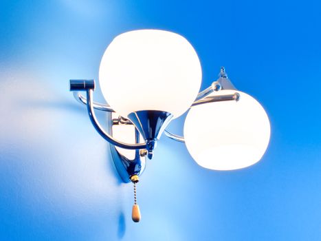 Lamp on textureized blue wall