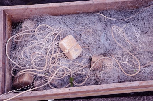 Fishing net in wooden box. Tool for fishing. Illegal fishing.