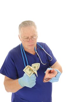 Doctor holding fist full of money repesentign the escalating costs of medical atention, and or body parts for sale