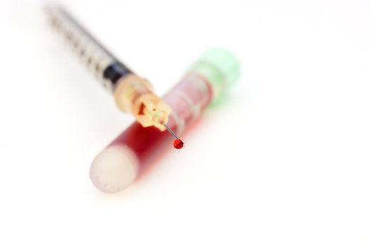 a blood droplet on a syringe needle after extraxting a sample for testing