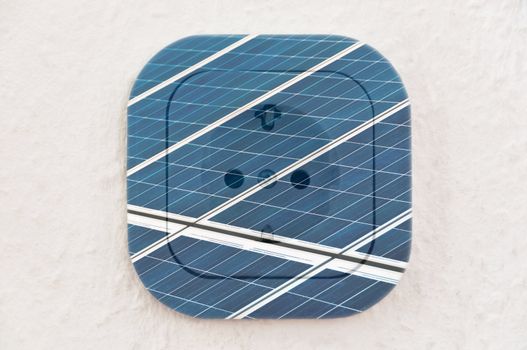 Conceptual: Solar Panels over power outlet on ingrain wallpaper. File contains clipping path.