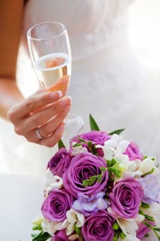 glass of champagne in a hand of a bride