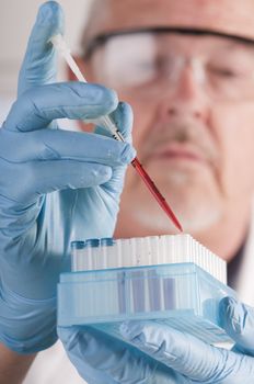 Research scientist with blood samples and culture dish for analysis