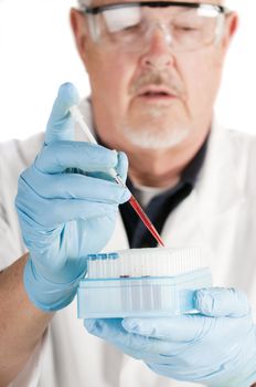shallow depth of field image of a Research scientist using a pippette with blood samples for analysis