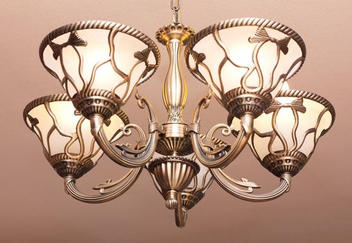 Contemporary old fashioned steel five light chandelier. Digital photograph.