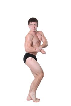 The young athlete the man poses on a white background