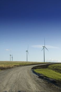 Alternate energy wind generators at the end of a dirt road