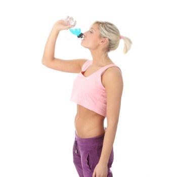 Beautiful caucasian fitness woman drinking energy drink from bottle, isolated