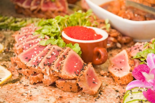 seared ahi tuna with tobiko roe on a granite table