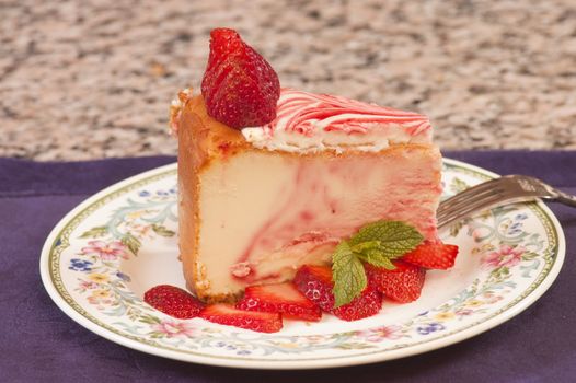 Plate of strawberry cheescake with fresh strawberries
