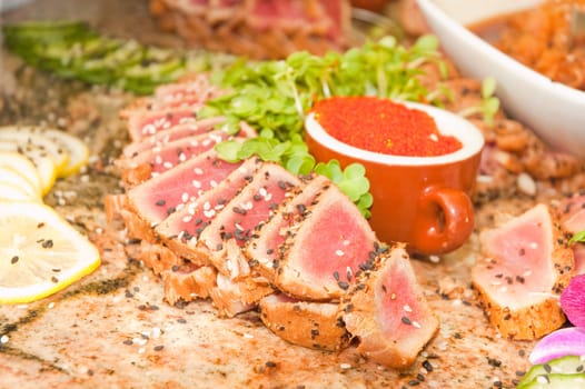 seared ahi tuna with tobiko roe on a granite table
