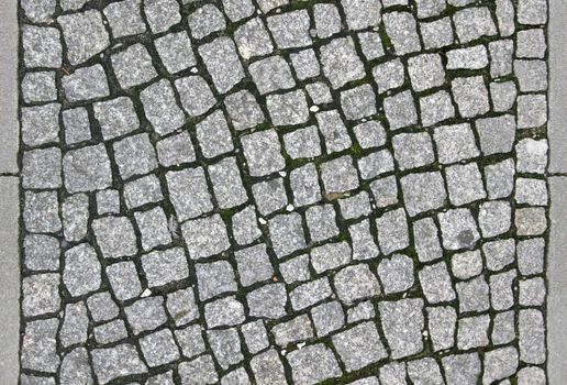 small cobblestone sidewalk made of cubic stones - tileable texture