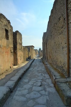 Narrow cobblestone street in the city of Pompeii, Southern Italy