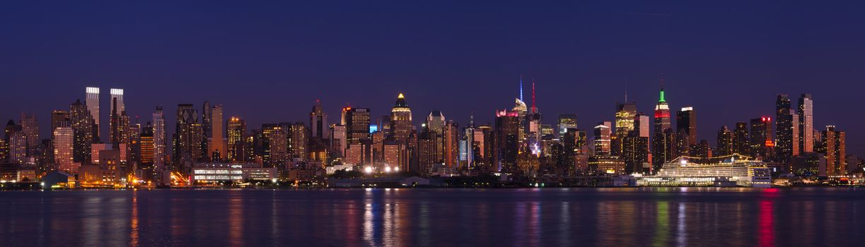 Panorama of Midtown Manhattan skyline and the Hudson River at night, New York City, New York, USA