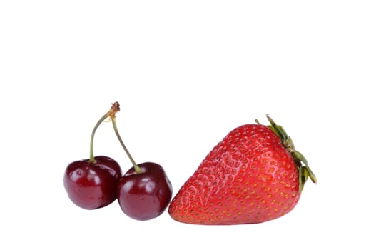 Two cherry's and a strawberry - isolated on a white background