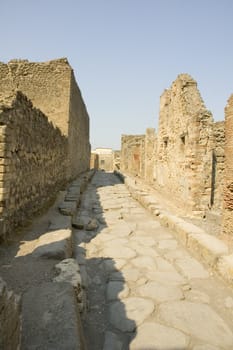 Narrow cobblestone street in the city of Pompeii