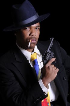 young African American man in a hat and suit with 38 revolver