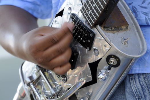 african american male lead guitarist playing in live concert