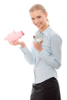 Young beautiful business woman with house model and piggy bank in hands, isolated on white background