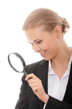 Young attractive smiling business woman looking into a magnifying glass, isolated on white background