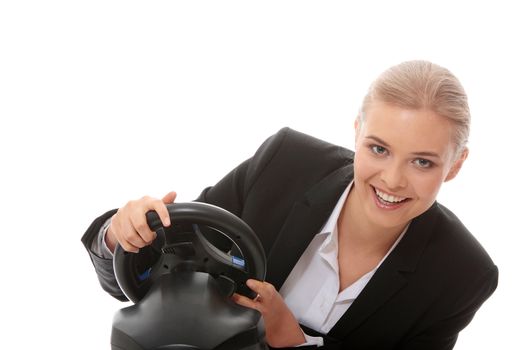 Young caucasian business woman playing on computer (with steering wheel), isolated on white background