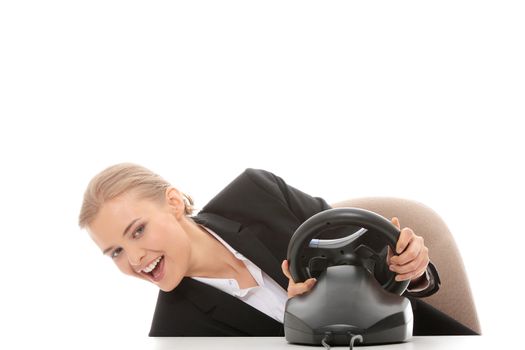 Young caucasian business woman playing on computer (with steering wheel), isolated on white background