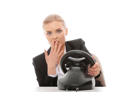 Young caucasian business woman playing on computer (with steering wheel), isolated on white background