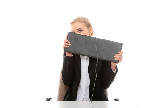 Scared business woman covering her face with keyboard, isolated on white background