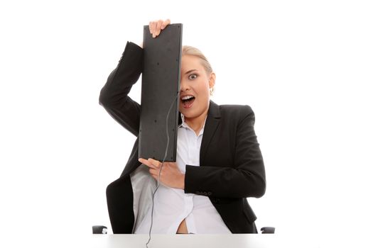 Scared business woman covering her face with keyboard, isolated on white background