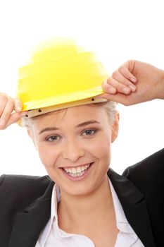 Portrait of confident female worker in helmet isolated on white background