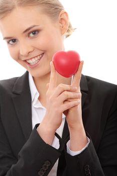 Young business woman holding heart shaped toy