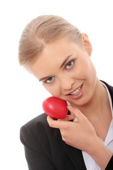 Young business woman holding heart shaped toy