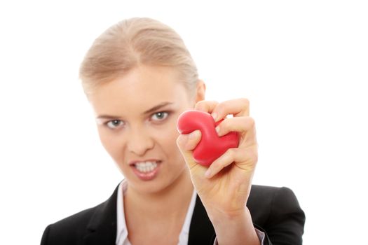 Young business woman holding heart shaped toy