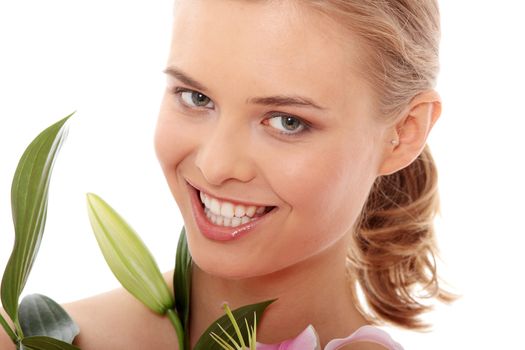 Portrait of the attractive girl without a make-up, with lily flower in hand, isolated on white background