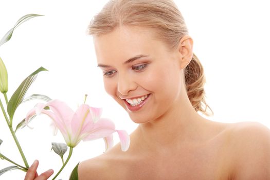 Portrait of the attractive girl without a make-up, with lily flower in hand, isolated on white background