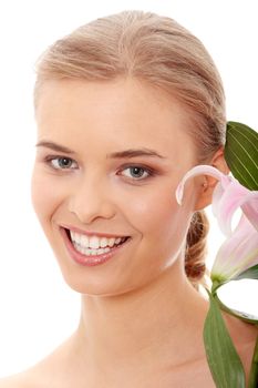 Portrait of the attractive girl without a make-up, with lily flower in hand, isolated on white background