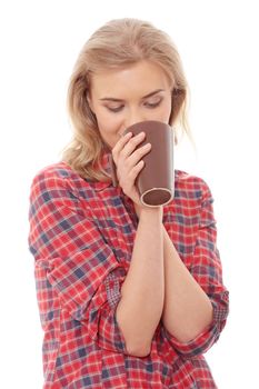 The beautiful young woman drinks morning coffee or tea