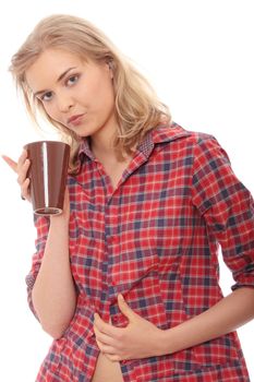 The beautiful young woman drinks morning coffee or tea