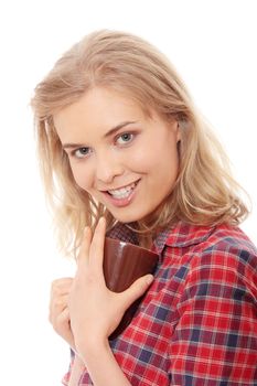 The beautiful young woman drinks morning coffee or tea