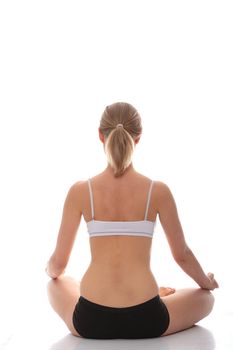 Young woman doing yoga exercise, isolated on white background