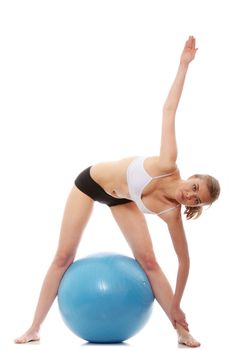 Young woman exercising with fitness ball. Isolated on white