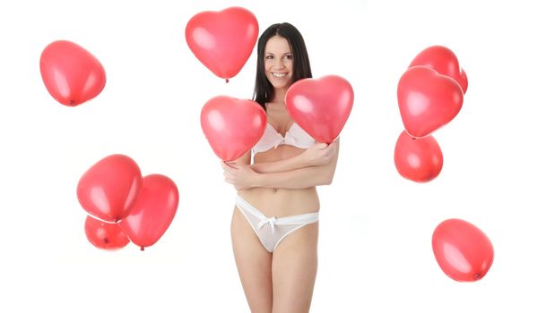 Beautiful young woman in lingerie with red heart balloon on a white background (love and valentines concept)