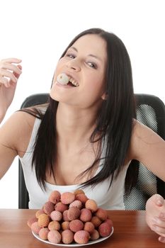 Young beautiful caucasian woman eating litchi fruits, isolated on whiet background