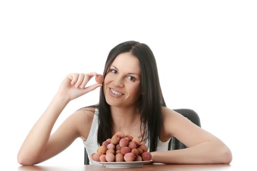 Young beautiful caucasian woman eating litchi fruits, isolated on whiet background